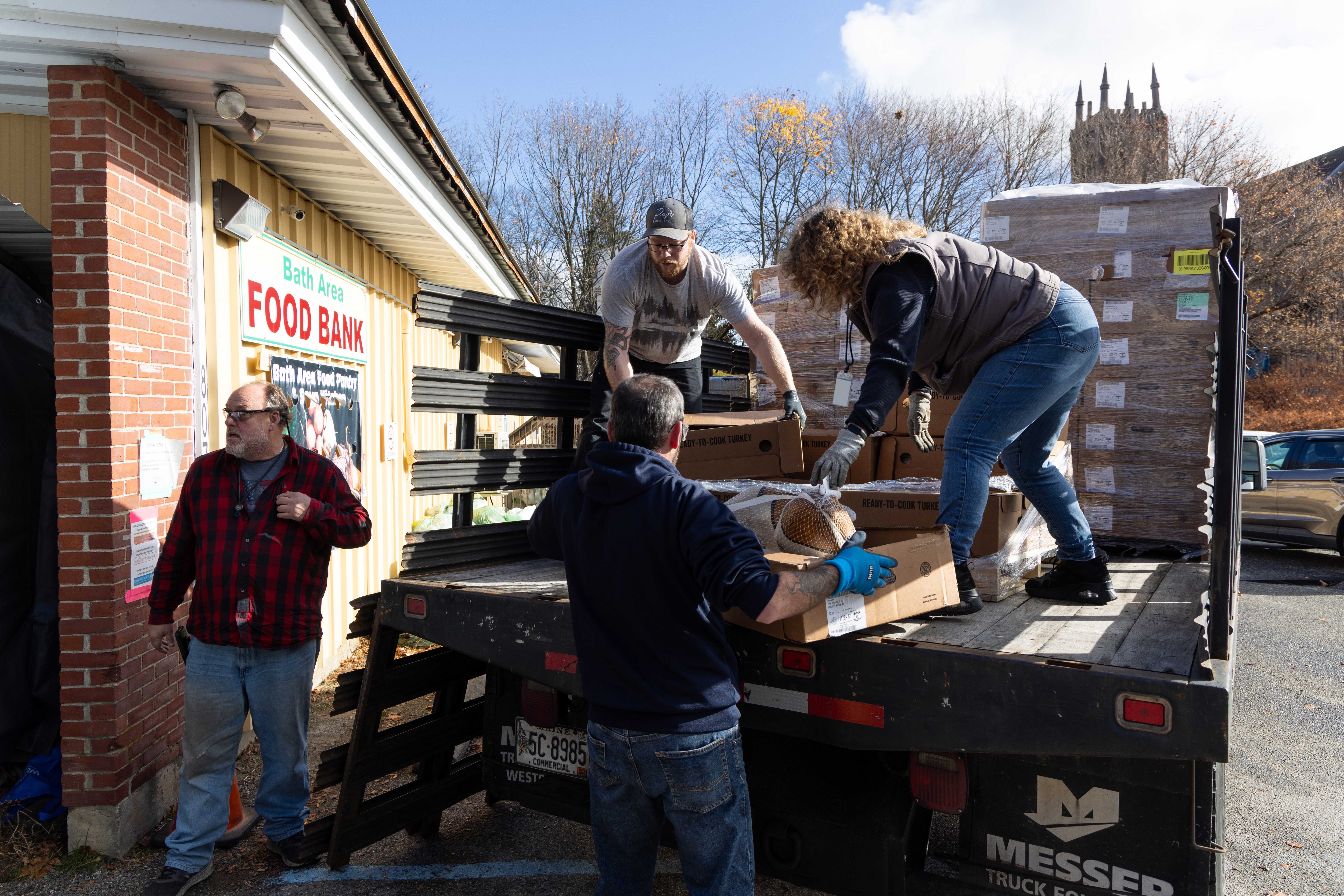 BIW employees unload turkeys donated to Bath Area Food Bank