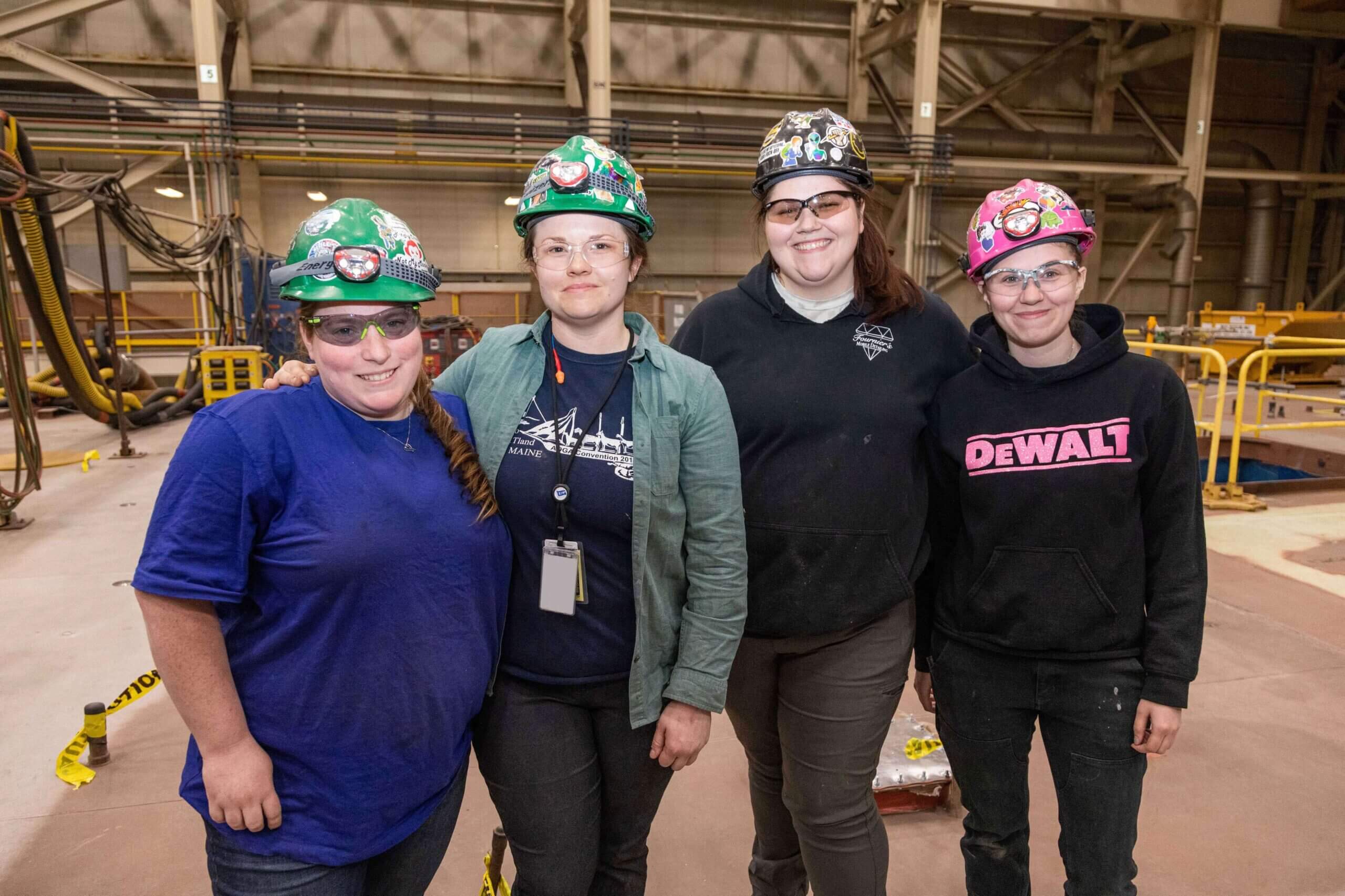 Four female shipbuilders celebrate ship keel laying at BIW