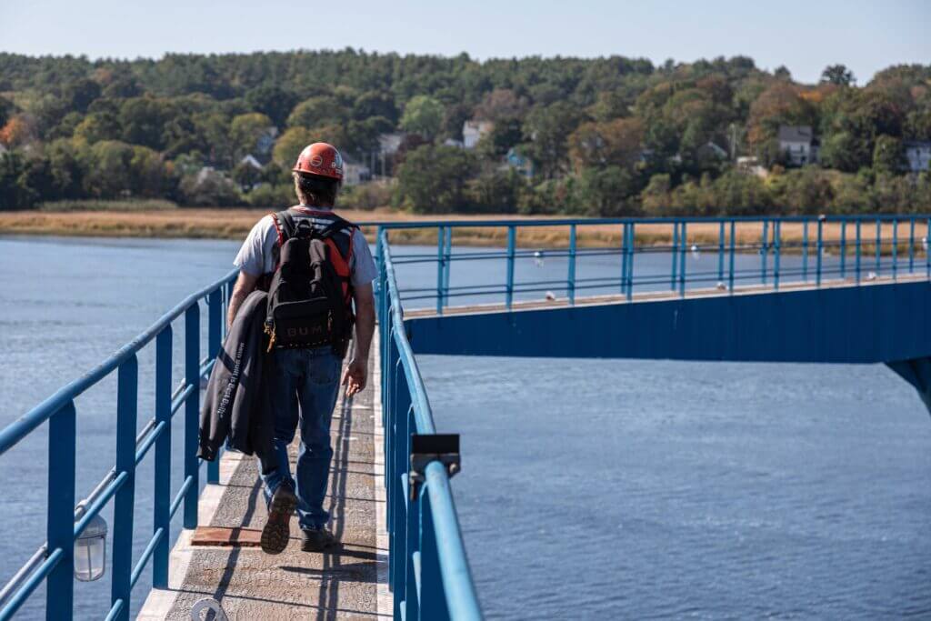 A shipbuilder walks on the drydock bridge