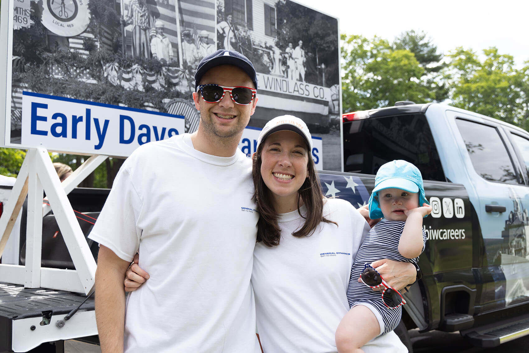 A family of three celebrate Fourth of July during Bath Heritage Days Parade