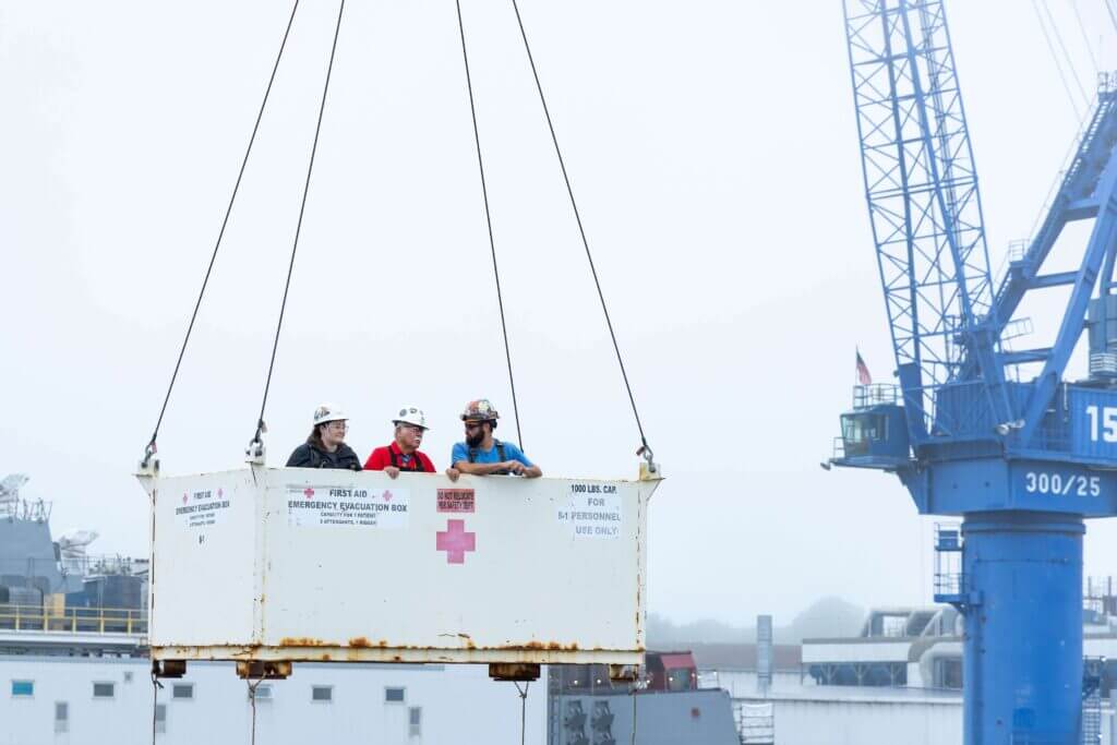 Harvey C. Barnum Jr. talks with BIW employees during crane lift