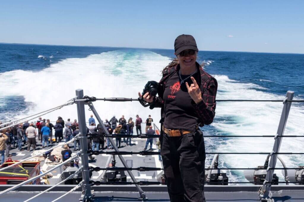A BIW employee poses at the aft end of DDG 122